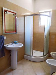 a bathroom with a shower and a sink and a toilet at Serenity's Sunset Terrace in Shkodër