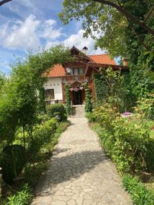 a house with a pathway in front of it at Orehite Guest House in Samokov