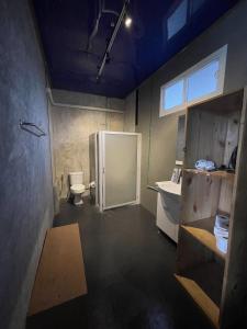 a bathroom with a refrigerator and a toilet at B Samcook Home16 in Chiang Mai
