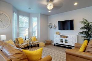 a living room with a couch and a flat screen tv at Southern Comfort-Pool! Hot Tub! in Washington