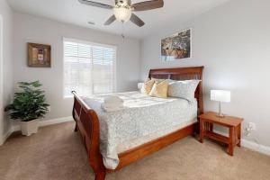 a bedroom with a bed and a ceiling fan at Southern Comfort-Pool! Hot Tub! in Washington