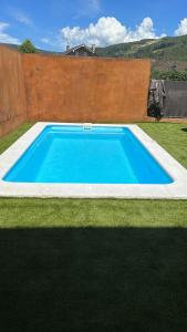 a large blue swimming pool in a yard at Casa Blanco Conde Pensión in Laza