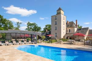 a swimming pool in front of a building at Relais Des Landes in Ouchamps
