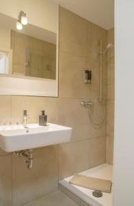 a bathroom with a sink and a shower at B&B Malú am Ring in Müllenbach