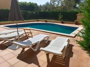 a group of chairs and a swimming pool at La Pallissa 9 in Torroella de Montgrí