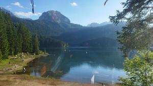 a view of a lake with people on the shore at durmitor_nature in Žabljak