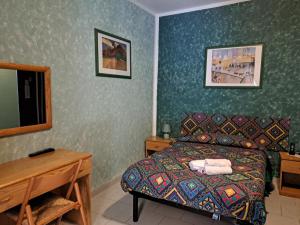 a bedroom with a bed and a table and a mirror at hotel Bologna in Fanano