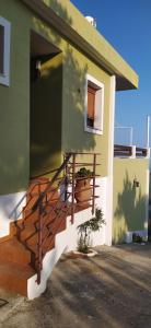 a house with a staircase on the side of it at VILLA VASO in Ierapetra