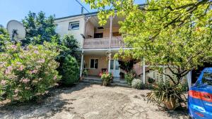 a house with a lot of plants in front of it at Kakheti Apartment in Dedoplis Tskaro