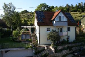 ein Haus mit Sonnenkollektoren auf dem Dach in der Unterkunft Ferienwohnung Lautertal Haus Barbara in Indelhausen