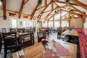 a dining room with wooden tables and chairs at Blumenhof Bucovina in Voronet