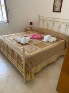 a large bed with two pillows on top of it at Villa Pineta in San Menaio