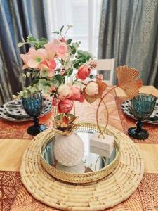 a table with a vase with flowers in it at Elon's Place in Catarman