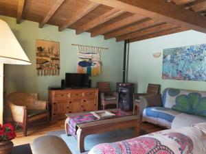 a living room with a couch and a table at Casa Rural EL RINCÓN DE LA MORAÑA in Fuente el Sauz