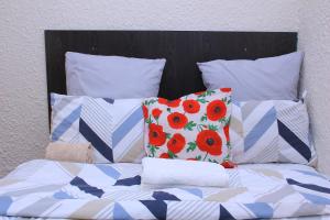 a bed with four pillows on top of it at MILLY GUEST HOUSE in Johannesburg