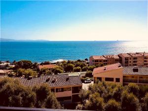 a view of the ocean from an apartment complex at Location corsica in Ajaccio