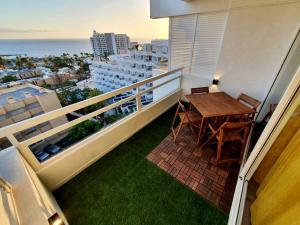 a balcony with a table and a view of the ocean at Stonefall Tenerife Holiday Apartment Las Americas in Playa Fañabe