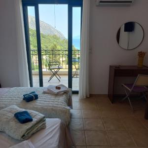 a hotel room with two beds and a balcony at Giannatos' Studios - Makis in Poros