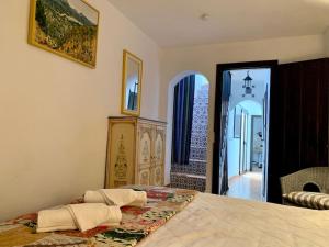 a bedroom with a large bed and an open doorway at Townhouse in Canillas de Aceituno in Canillas de Aceituno