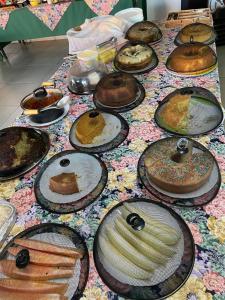 a table topped with lots of different types of cakes at Hotel Campina in Posse
