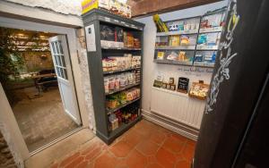 a store aisle with an open refrigerator with food at High Paradise Farm in Thirsk