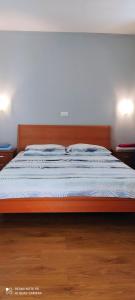 a bedroom with a bed with a wooden frame at Apartments Sandra in Vrsar