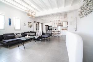 a living room with a couch and a table at Villa with Private Pool in Panormos in Mykonos