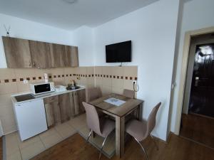 a kitchen with a table and chairs and a microwave at SAGA 307 in Jagodina