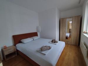 een slaapkamer met een wit bed en 2 handdoeken bij SAGA 307 in Jagodina
