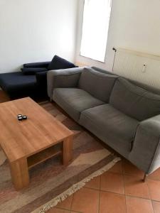 a living room with a couch and a coffee table at Apartment in Nijmegen voor 3 personen in Kranenburg