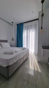 a bedroom with a large bed and a window at Danielli Luxury Villas in Skala Rachoniou