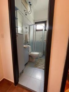 a bathroom with a toilet and a shower and a sink at Guest House Anna in Kruče