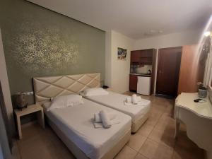 a hotel room with two beds and a kitchen at FEDRA HOTEL in Paralia Katerinis