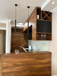 a kitchen with wooden cabinets and a wooden counter top at Exclusive Apartment in Rafailovici