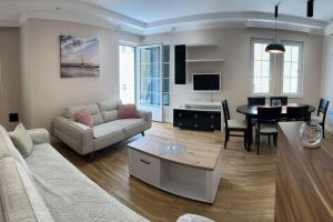 a living room with a couch and a table at Exclusive Apartment in Rafailovici