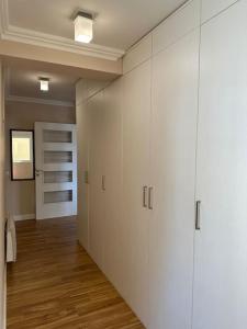 a hallway with white cabinets in a room at Exclusive Apartment in Rafailovici