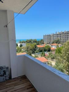 a room with a balcony with a view of a city at ABX seaview Apartment in Golem