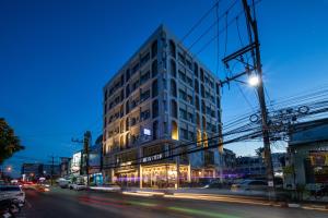a tall building on a city street at night at Montree Phuket Hotel in Phuket Town