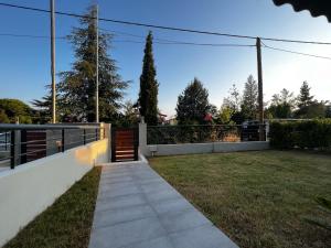 a walkway in a yard with a fence at Kalisti Relax Villa in Nikiti