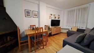 a living room with a table and a couch at ssolivellasscanfranc in Canfranc-Estación