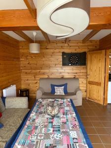 a living room with a bed and a couch at Cabaña con encanto y vistas increíbles!! in Sierra Nevada