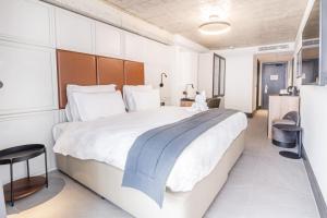 a bedroom with a large bed in a room at The Londoner Hotel Sliema in Sliema