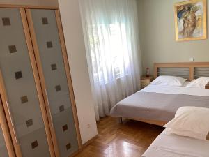 Posteľ alebo postele v izbe v ubytovaní Apartman Brankica