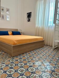 a bedroom with a bed and a floor at B&B Palazzo Corselli in Bagheria