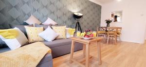 a living room with a couch and a table at 2 Single Beds, 1 BR Apartment in Newmarket