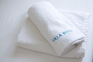 a stack of white towels with the word malaria on them at Villa Irene in Pefkohori +79 photos