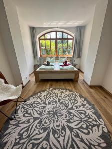a large room with a bed and a large window at Ferienwohnung Schwaiger am Königssee in Schönau am Königssee
