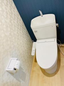 a white toilet in a bathroom with a scale at ROYAL YONEGAHAMA ｌ米が浜通 in Kusugaurachō