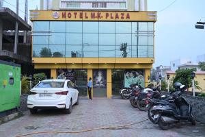 a car is parked in front of a hotel margaza at Hotel M K Plaza in Bodh Gaya