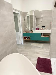 a bathroom with a sink and a mirror at Villa au milieu des vignes in Saint-Marcel